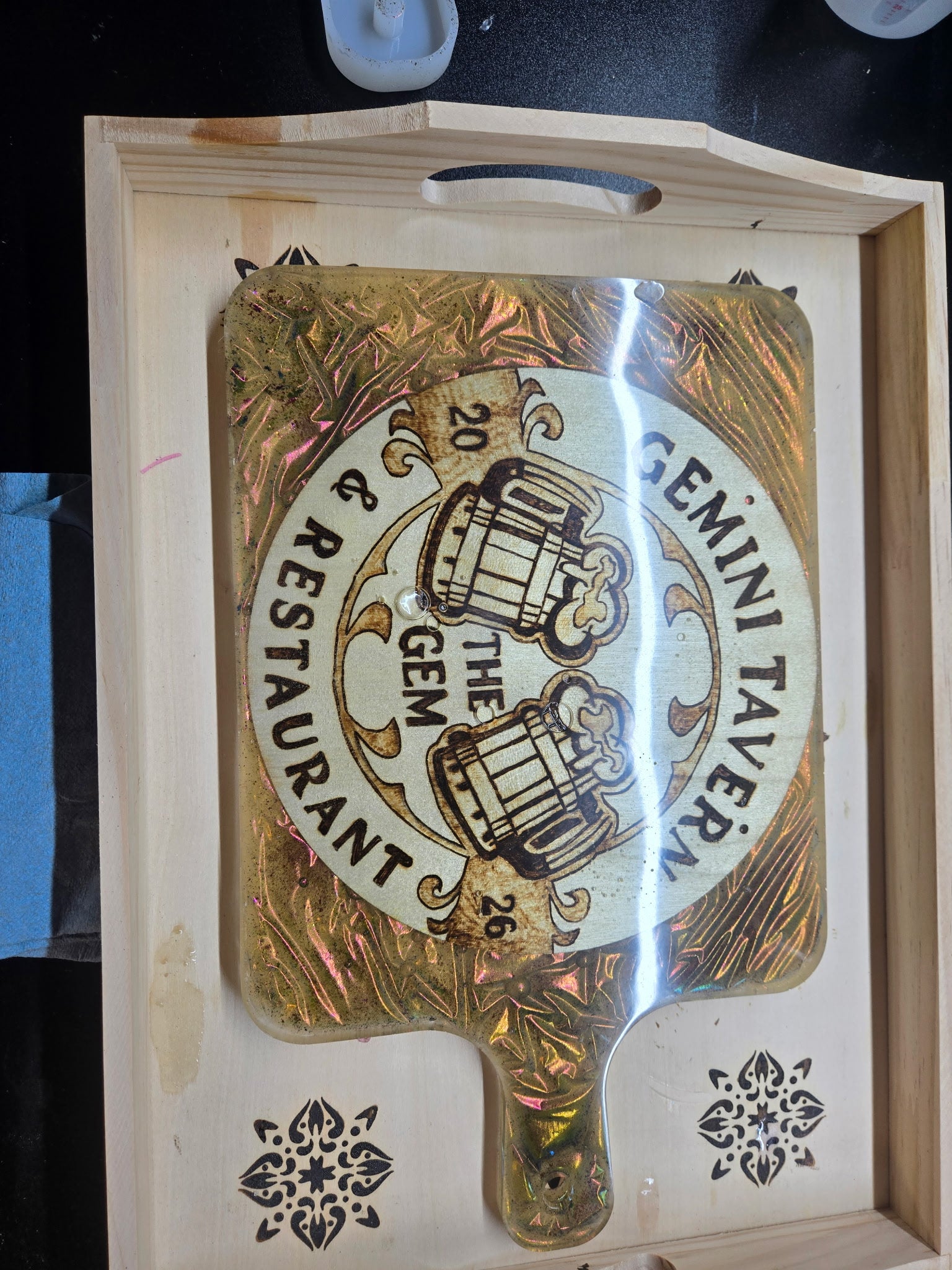 Custom resin prep board with gold resin pour and personalized tavern logo on solid wood