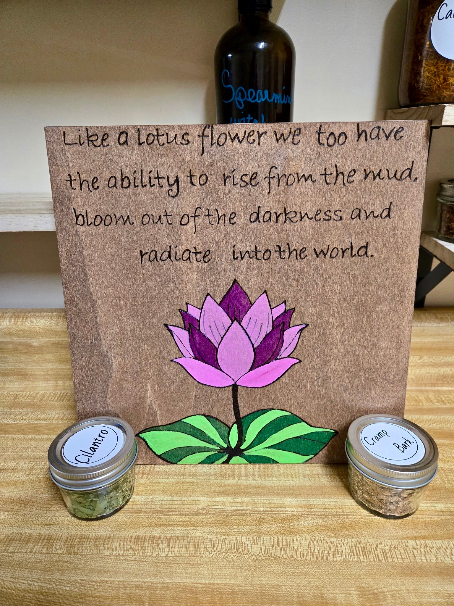 Hand burned and colored wood wall art with lotus flower and inspirational quote on wood panel