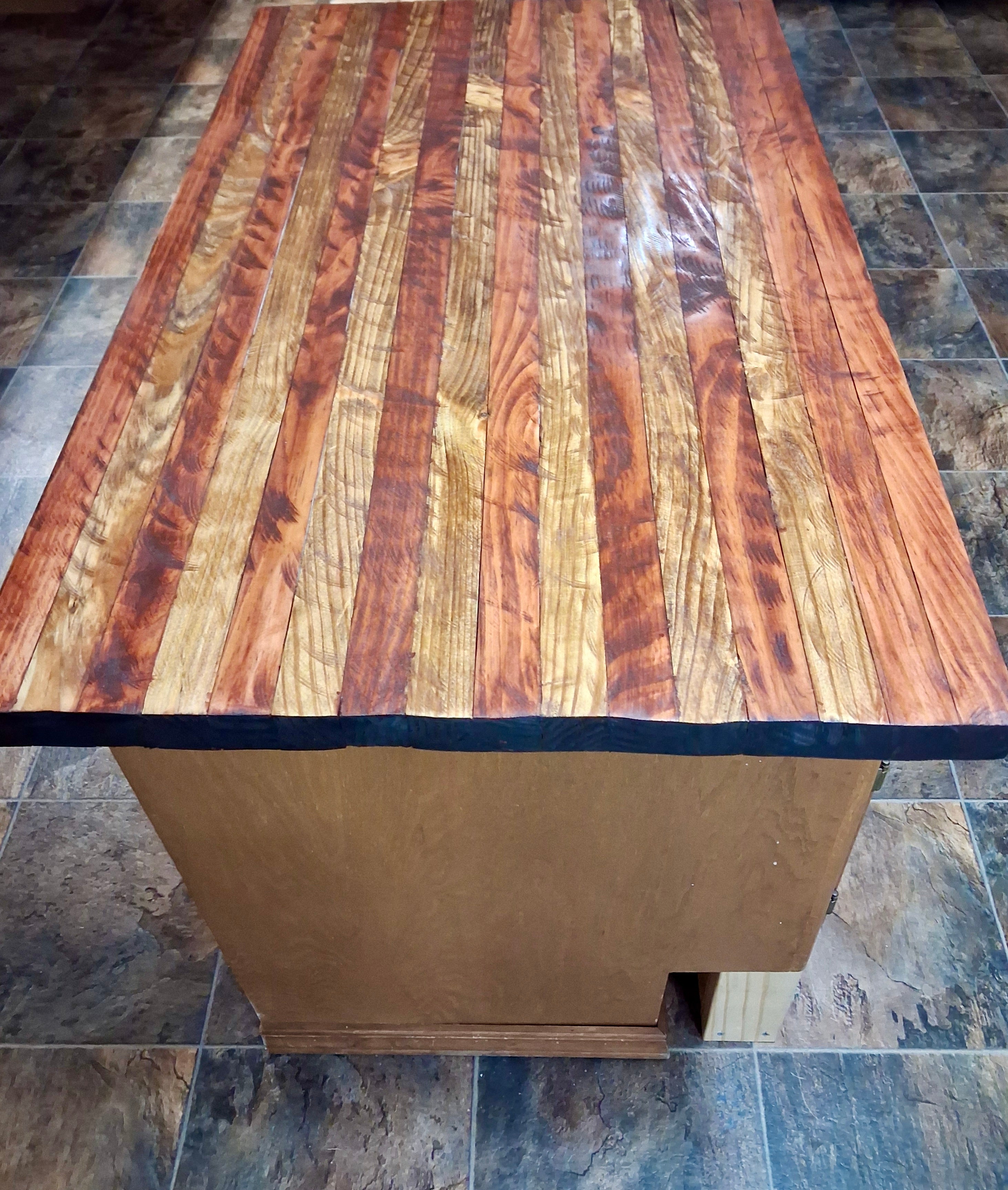 Hand cut stained and sealed rustic kitchen island top with rich wood grain and deep blue resin edge detail