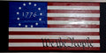 Handcrafted wooden Betsy Ross flag with 13 stars, 1776 date, and We the People script